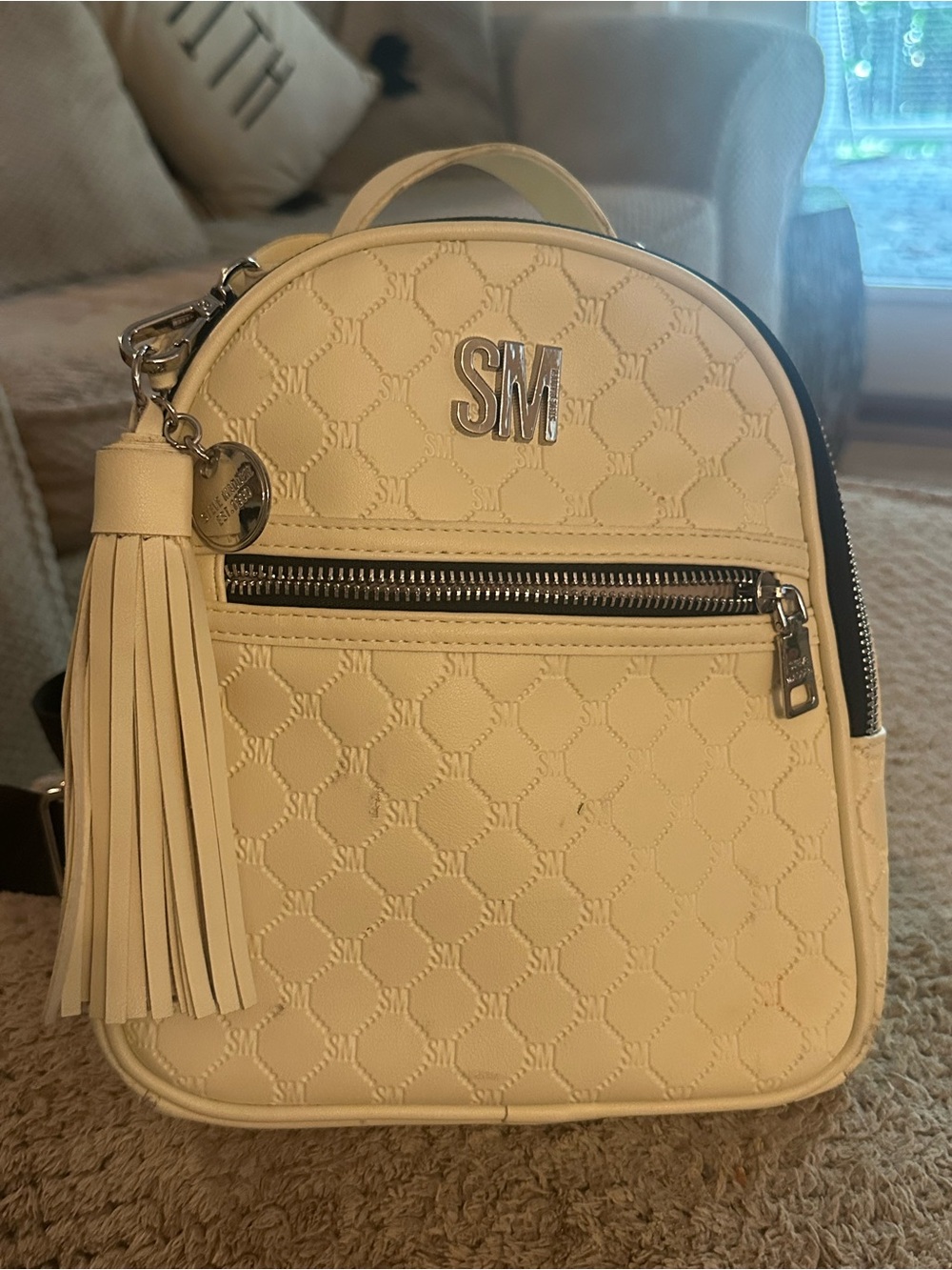 STEVE MADDEN Monogram Cream Mini Backpack with Tassel Charm